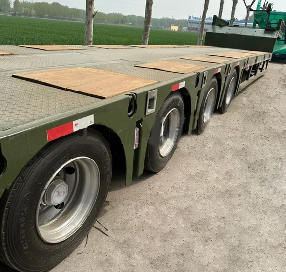 Heavy equipment transport with lowboy trailers